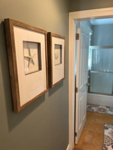 two picture frames on a wall with a starfish on it at Amazing Gold Coast Property in Ocean City