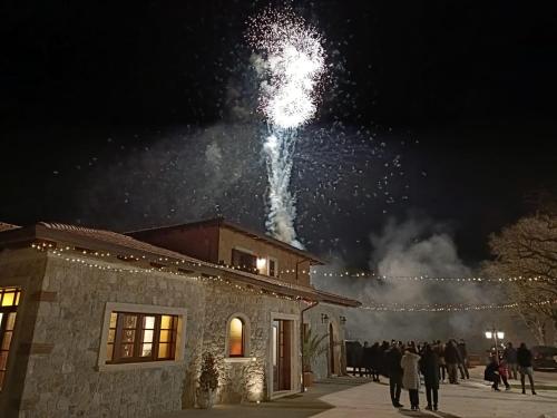 a group of people standing outside of a building with fireworks at TENUTA ROSA - Gastronomia e Relax in Montesano Scalo