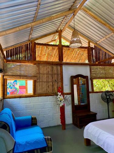 a room with a bed and a chair and a table at Finca Ecoturistica LOS JAGUEYES in Baraya