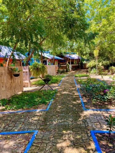 a path in a garden with blue tiles on it at Finca Ecoturistica LOS JAGUEYES in Baraya