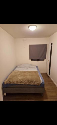 a bedroom with a bed and a flat screen tv at Nydelig leilighet til leie in Halden