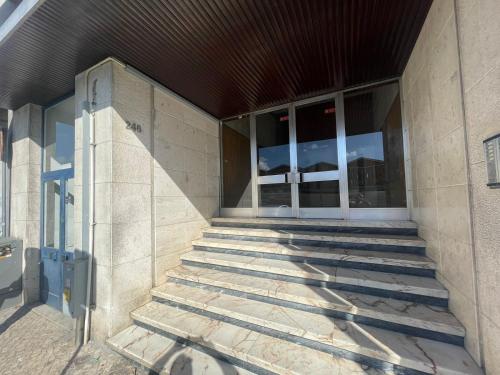 a building with stairs leading into a building at Flor da Providência in Viseu