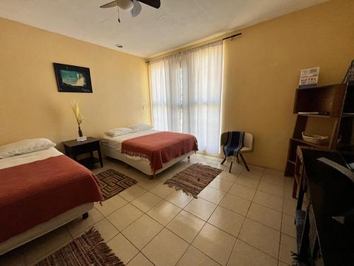 a hotel room with two beds and a window at Hotel Senda del Ángel in Zorita