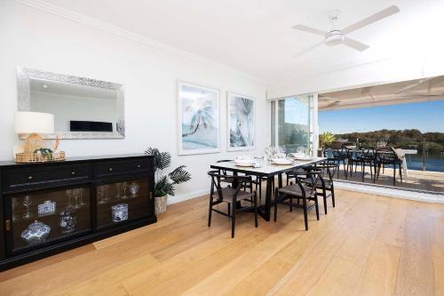 a dining room with a table and chairs at Regatta 17 in Forster