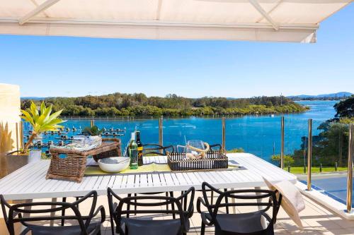 a table with chairs and a view of the water at Regatta 17 in Forster