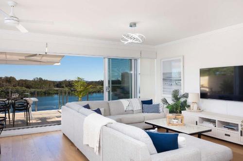 a living room with a couch and a large window at Regatta 17 in Forster