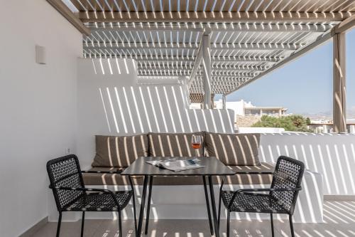 a patio with a table and chairs and a couch at Lianos Village in Agios Prokopios