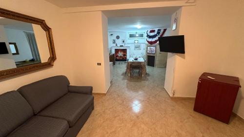 a living room with a couch and a mirror at B&B Mamma Mia s in Airola
