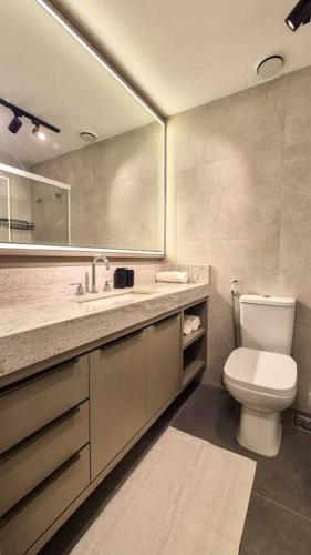 a bathroom with a toilet and a sink and a mirror at Copacabana Amazing in Rio de Janeiro