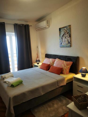 a bedroom with a large bed with colorful pillows at Apartment Ana in Senj