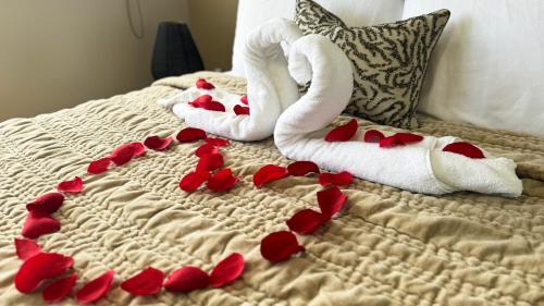 a bed with red hearts and towels on it at Ocean Luxe in Paradise - Les Chambres des Dieux in Rincon