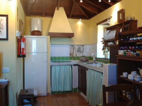 een keuken met een witte koelkast en een wastafel bij Casa Rural Las Piedras in Buenavista del Norte