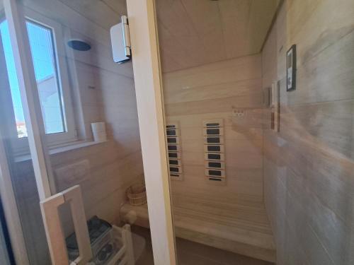 a small bathroom with a toilet and a window at Villa Miri III in Privlaka