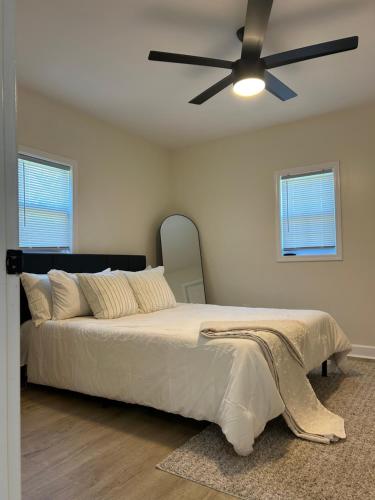a bedroom with a bed with a ceiling fan at Newly Renovated Home Near DT in Anderson