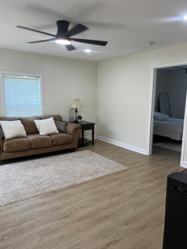 a living room with a couch and a ceiling fan at Newly Renovated Home Near DT in Anderson