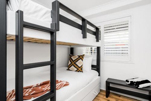 a bunk bed in a bedroom with a bunk bed in a room at 3 Salty Sisters in Byron Bay