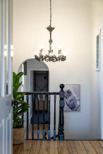a chandelier hanging over a staircase in a hallway at The White House Molong in Molong