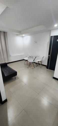 a room with two chairs and a bed in it at Apart Hotel Osaka 4 Personas in Iquique