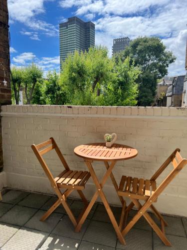 a table and two chairs on a patio at Lovely Entire Flat with Private Balcony in Euston-Central London in London