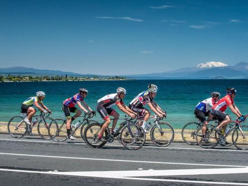 a group of people riding bikes down a road at Little Haven in Taupo