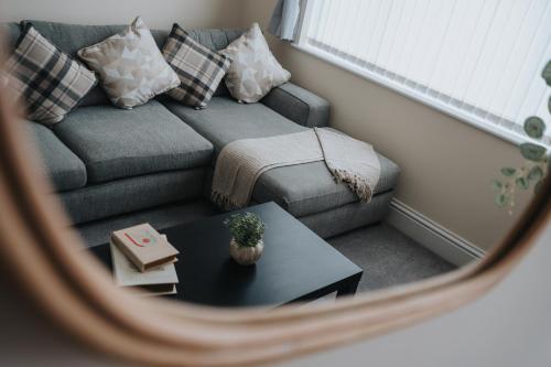 a small living room with a couch and a table at Large cosy house - free on street parking in Liverpool