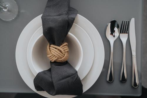 a plate with a black tie sitting on a table at Large cosy house - free on street parking in Liverpool