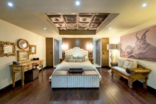 a large bedroom with a bed and a couch at Palala Boutique Game Lodge and Spa in Tom Burke