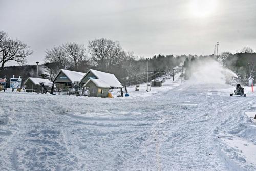 a person riding a snowmobile down a snow covered slope at BigBoulder Lakeview Terrace-Minutes from the Lake in Lake Harmony