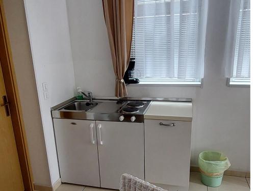 a small kitchen with a sink and a window at Apartmani Katarina in Makarska