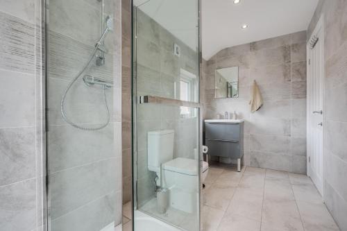 a bathroom with a shower and a toilet at Large cosy house - free on street parking in Liverpool