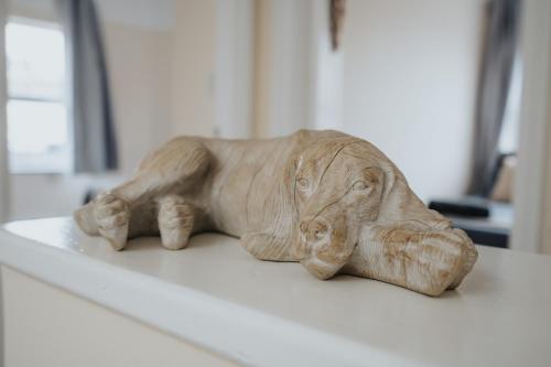 a wooden dog statue sitting on a table at Large cosy house - free on street parking in Liverpool