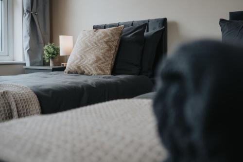 a bedroom with a bed and a couch with a pillow at Large cosy house - free on street parking in Liverpool