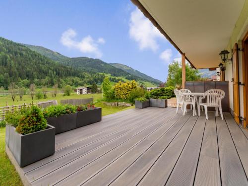 a deck with a table and chairs on a house at Hilde in Zirkitzen