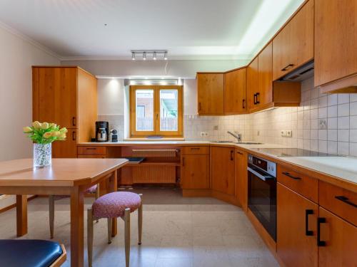 a kitchen with wooden cabinets and a table and a window at Hilde in Zirkitzen