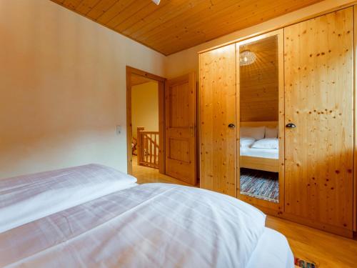 a bedroom with a bed and a wooden wall at Hilde in Zirkitzen