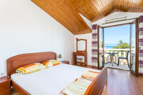 a bedroom with a bed and a view of the ocean at Apartments with parking space Supetar, Brac - 5670 in Supetar