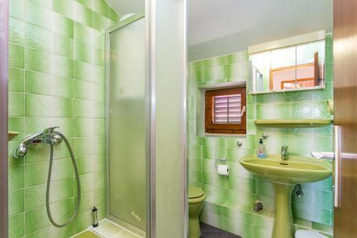 a bathroom with a shower and a sink at Apartments with parking space Supetar, Brac - 5670 in Supetar