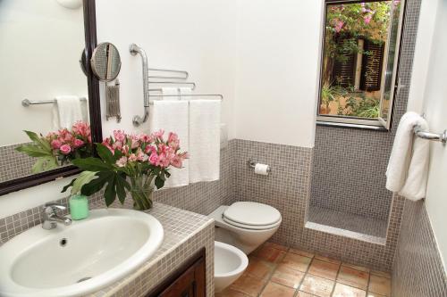 a bathroom with a sink and a toilet and a mirror at Torre Di Sebastiano in Gaggi