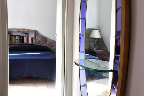 a room with a bed and a glass table at Torre Di Sebastiano in Gaggi