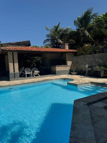 a swimming pool in front of a house at Villa Jaguaribe in Fortim