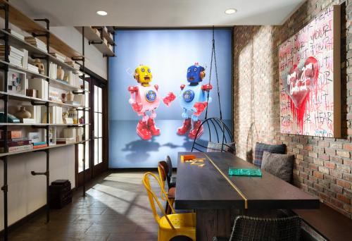 a dining room with a table and balloons on the wall at Moxy Santa Barbara in Santa Barbara