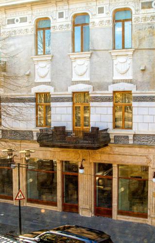 a building with a lot of windows on a street at Belona Hotel in Kutaisi