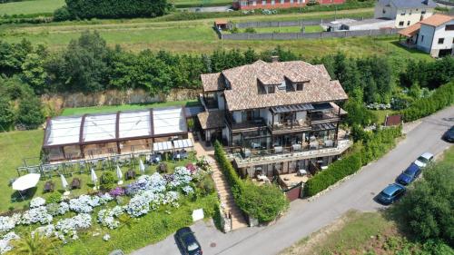 an aerial view of a house with a garden at Hotel Rural Playa de Aguilar in Muros de Nal&oacute;n