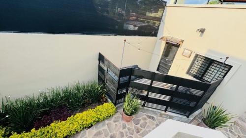 a balcony with plants and a black railing at San Angel Villas in San Antonio