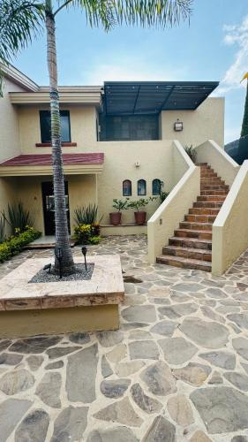 a house with a palm tree in front of it at San Angel Villas in San Antonio