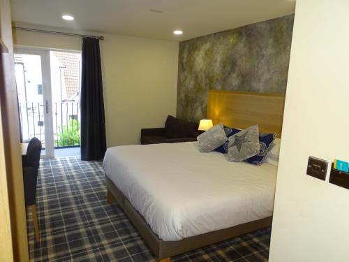 a hotel room with a bed and a couch at Oddfellows Hotel in Carlton