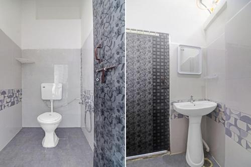a bathroom with a toilet and a sink at Super Hotel O Alwal Residency in Hyderabad