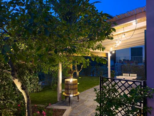 a patio with a bench and a tree at La Casa dei Glicini in Levanto