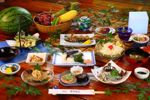 a table with many plates of food on it at 民宿ひろしげ in Izuno