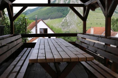 a wooden bench sitting on top of a wooden table at Long Rock Chalets in Rimetea
